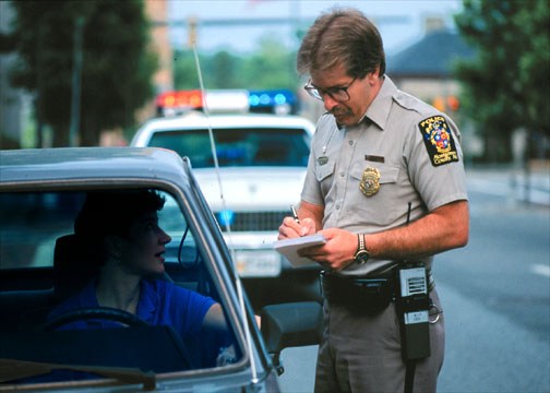 a man standing next to a car